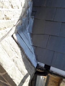 lead work adjoining stone chimney and tiled roof
